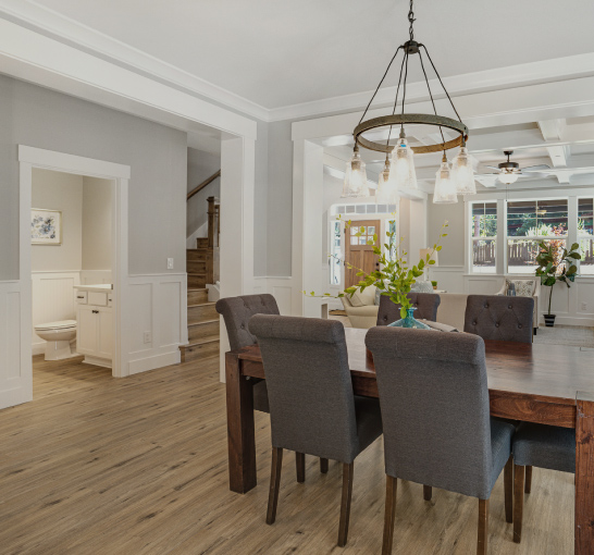 View through an open concept dining area to the front entry of a Rosetown Builders home